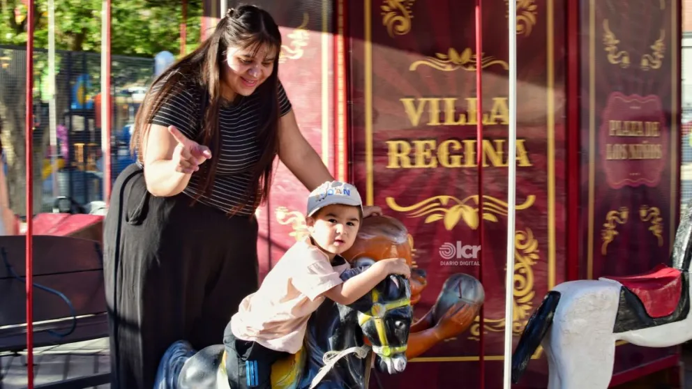 Rocío y su pequeño hijo posaron para LCR mientras disfrutaban de la histórica calesita en la plaza Primeros Pobladores. Foto: Celeste Cerezuela 